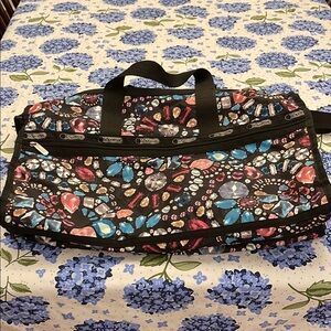 Lesportsac Black Travel Bags with Durable Fabric and Whimsical Design